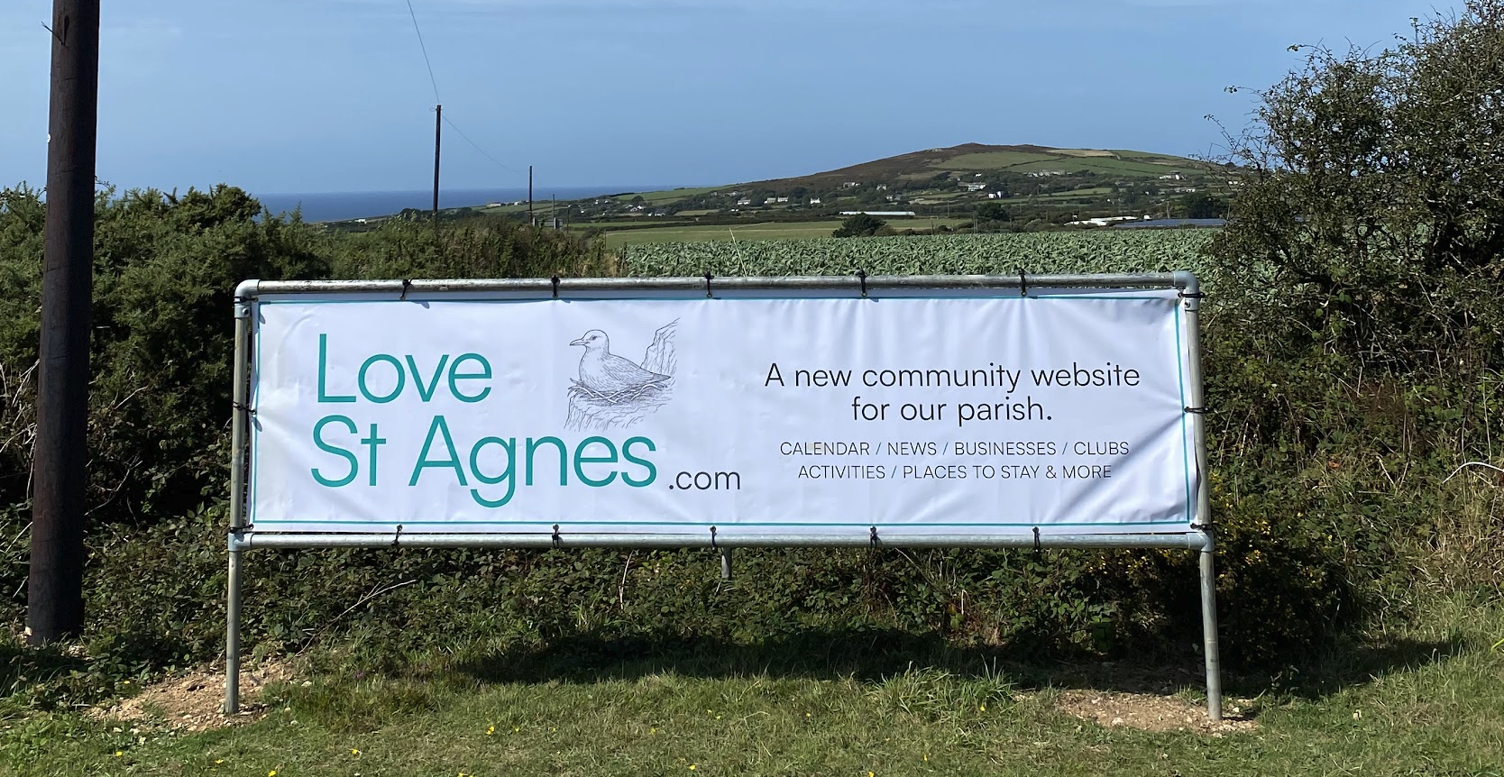 A banner for "Love St Agnes .com" a new community website, with a drawing of a bird in a nest.