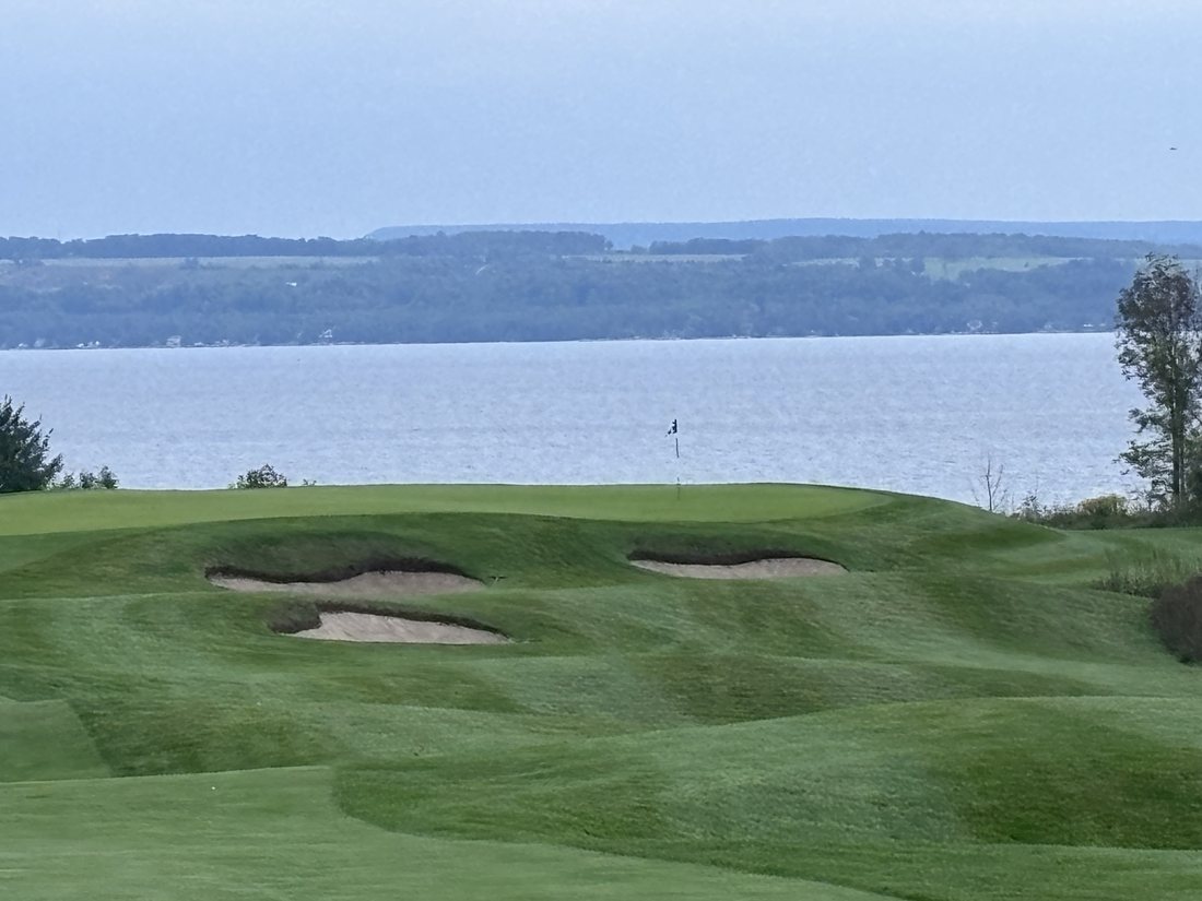 Green and bunkers at Cobble Beach with Georgian Bay behind
